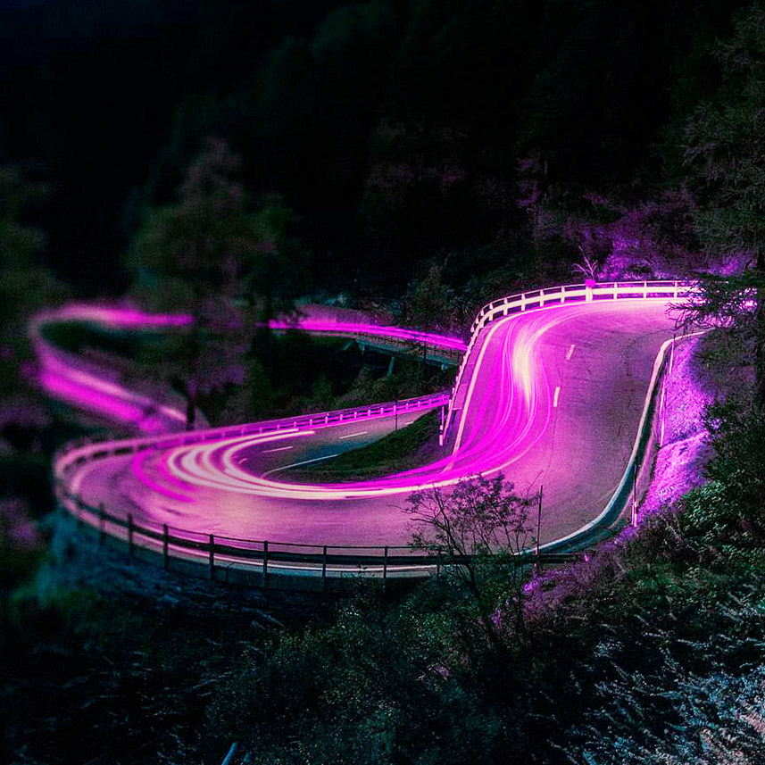 highway lit in purple crossing through wooded area, Autonomous Driving | DXC Technology